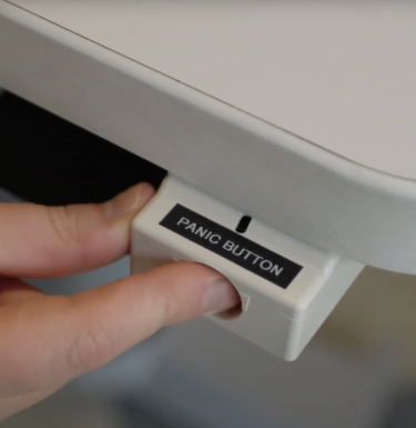 Fingers pushing a panic button