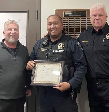 Officer Terry Stoudmire with Ted Fritz and Chief Jim Loftus.